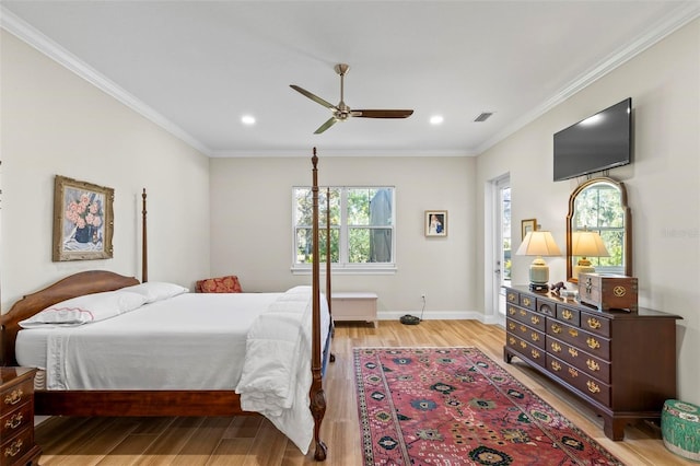 bedroom featuring ceiling fan, light wood-type flooring, and crown molding