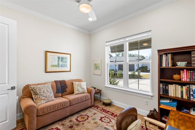 living area with hardwood / wood-style floors, ceiling fan, and ornamental molding