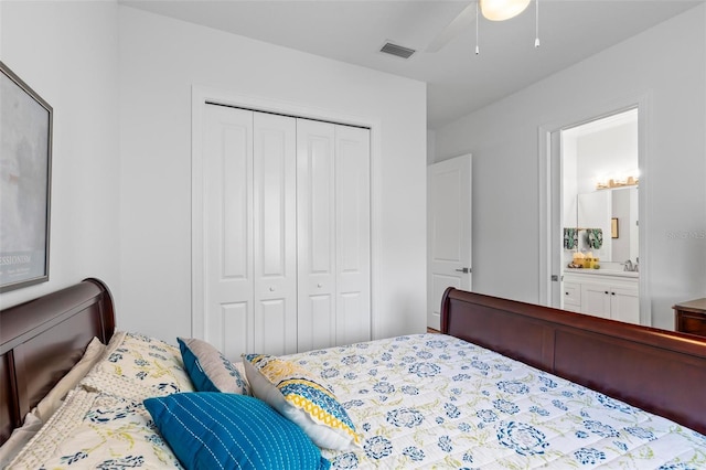 bedroom featuring ensuite bathroom, ceiling fan, a closet, and sink