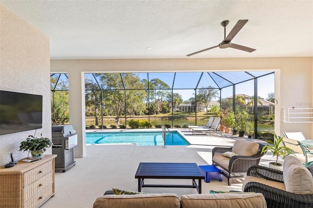 view of swimming pool featuring a patio area, outdoor lounge area, glass enclosure, and a water view