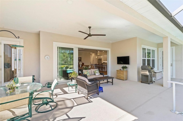 living room with ceiling fan and a wealth of natural light