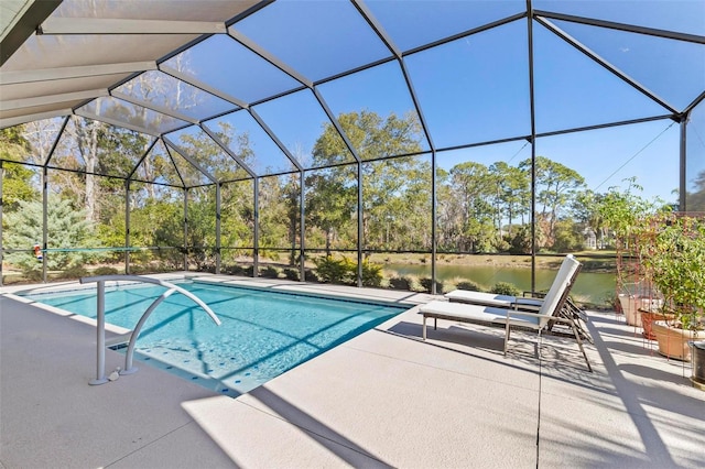 view of swimming pool featuring a patio area, glass enclosure, and a water view