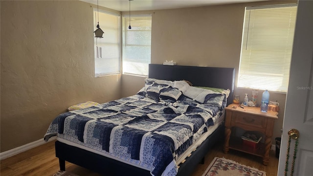 bedroom with wood-type flooring