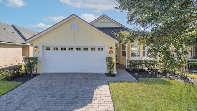 view of front of house featuring a garage and a front lawn