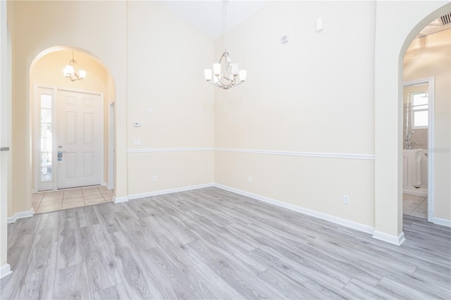 foyer featuring lofted ceiling and light hardwood / wood-style flooring