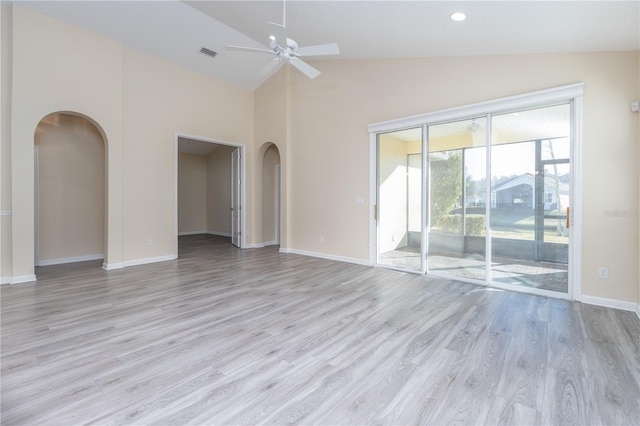 empty room with high vaulted ceiling, ceiling fan, and light hardwood / wood-style flooring