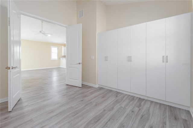 unfurnished bedroom featuring light wood-type flooring and a closet