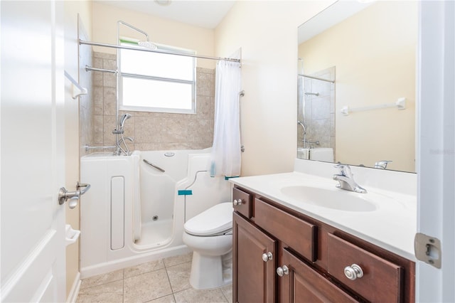 bathroom with a tub to relax in, tile patterned flooring, vanity, and toilet