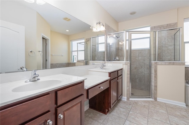 bathroom featuring tile patterned flooring, an enclosed shower, and vanity