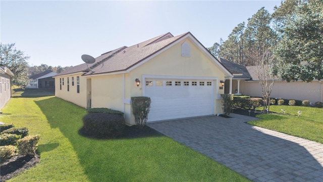 view of side of home featuring a yard and a garage