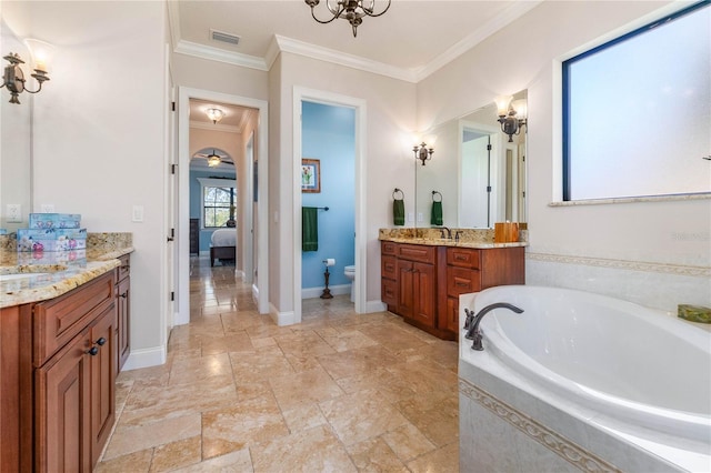 bathroom featuring vanity, toilet, a chandelier, a relaxing tiled tub, and crown molding