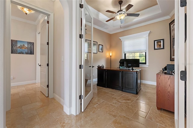 office with ceiling fan, crown molding, and a raised ceiling