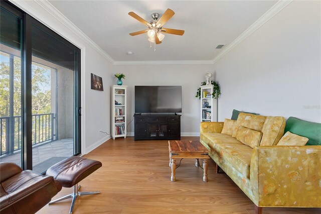 living room with ceiling fan, light hardwood / wood-style flooring, and ornamental molding