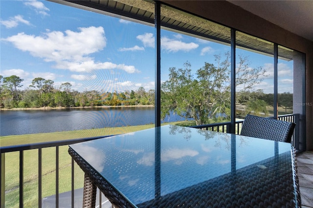 unfurnished sunroom featuring a water view