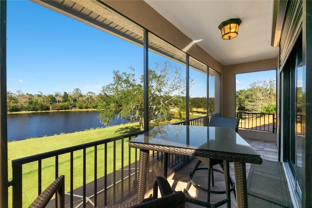 unfurnished sunroom featuring a water view