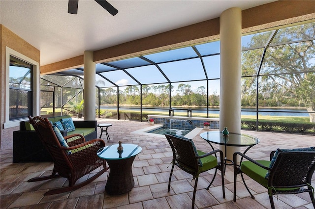 view of patio / terrace with ceiling fan, glass enclosure, and outdoor lounge area