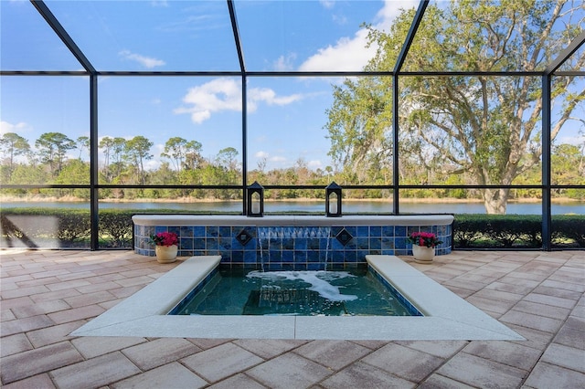 view of pool with a lanai, a water view, and a patio