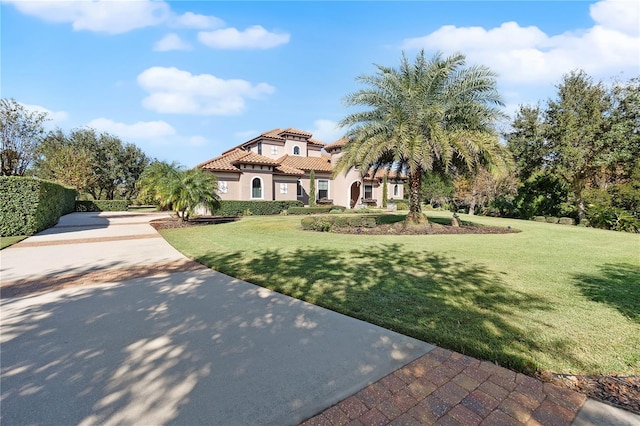 mediterranean / spanish home featuring a front lawn