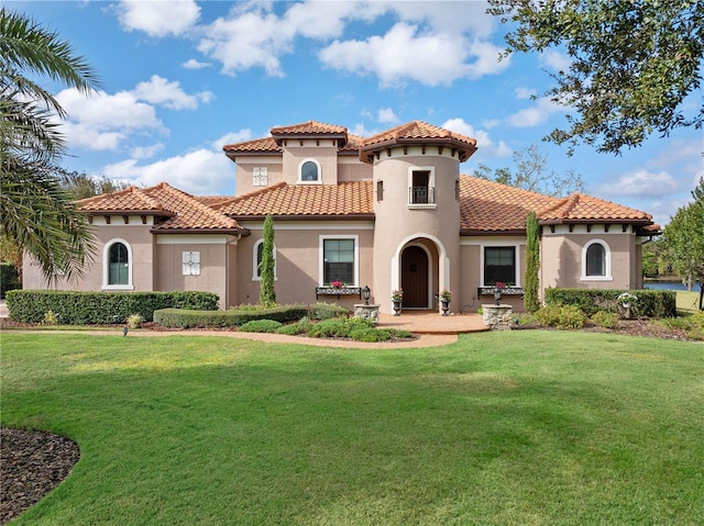 mediterranean / spanish-style house featuring a front lawn