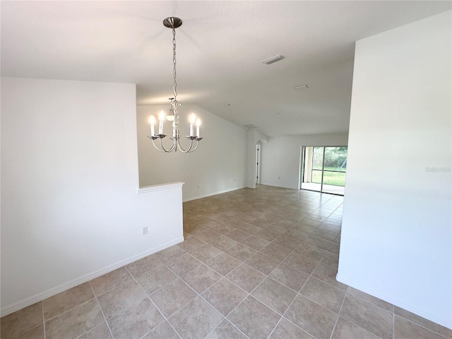 empty room with lofted ceiling and a chandelier