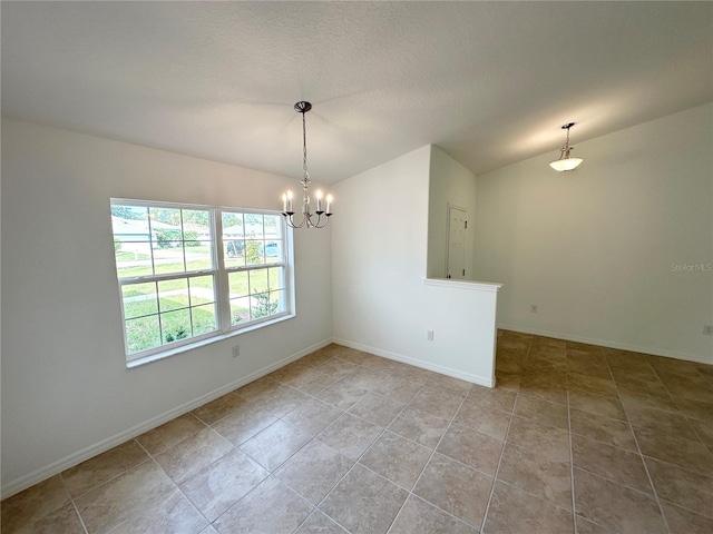 tiled spare room featuring an inviting chandelier