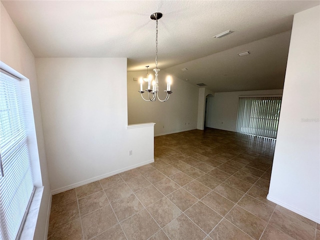 unfurnished dining area featuring vaulted ceiling and a notable chandelier