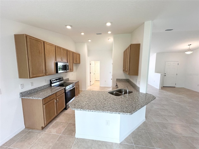 kitchen with kitchen peninsula, light stone countertops, light tile patterned floors, appliances with stainless steel finishes, and sink