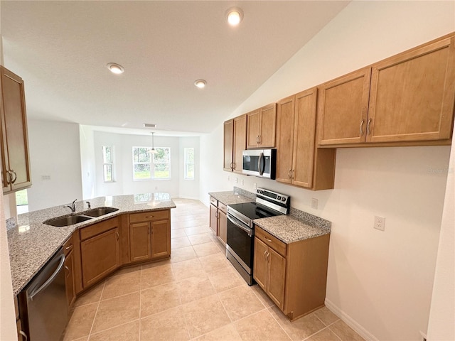 kitchen with stainless steel appliances, sink, light stone counters, lofted ceiling, and light tile patterned floors