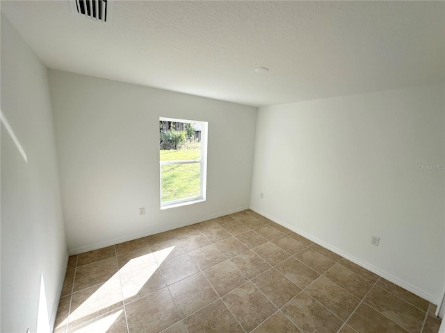 unfurnished room with light tile patterned flooring