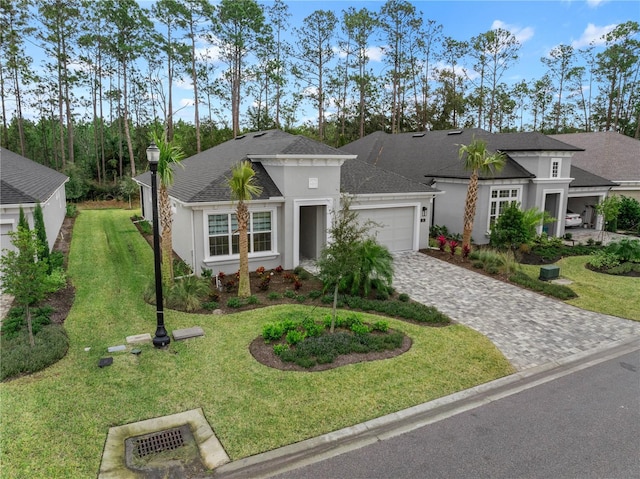 view of front facade with a front yard and a garage