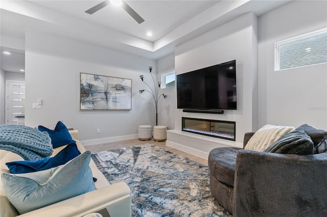 living room with hardwood / wood-style flooring and ceiling fan