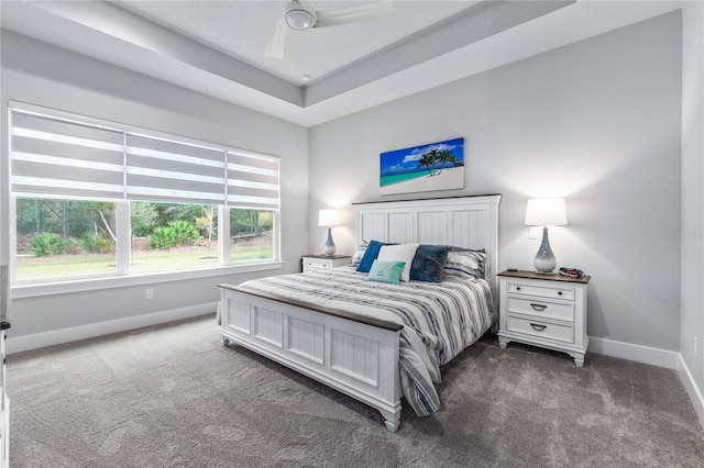 bedroom with ceiling fan and dark colored carpet