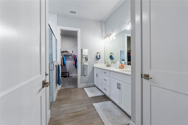 bathroom with vanity and hardwood / wood-style flooring