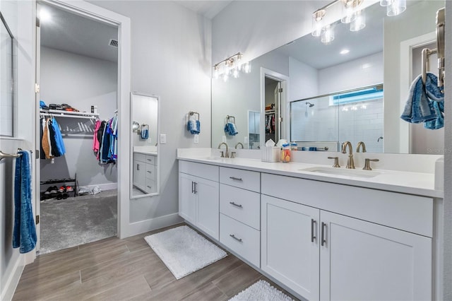 bathroom featuring vanity and a shower with shower door