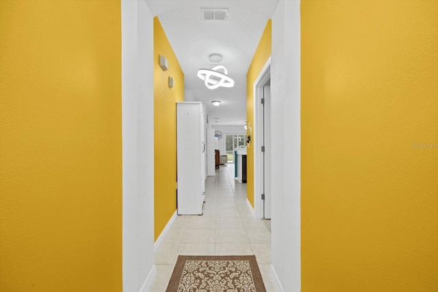 hallway featuring light tile patterned floors