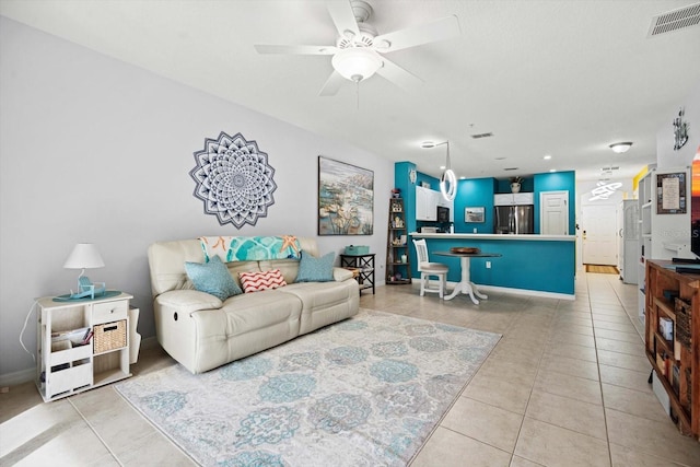 living room with ceiling fan and light tile patterned floors