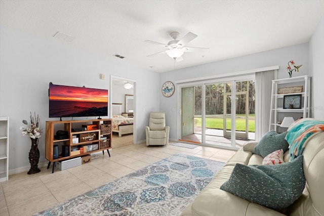 living room with ceiling fan and light tile patterned floors