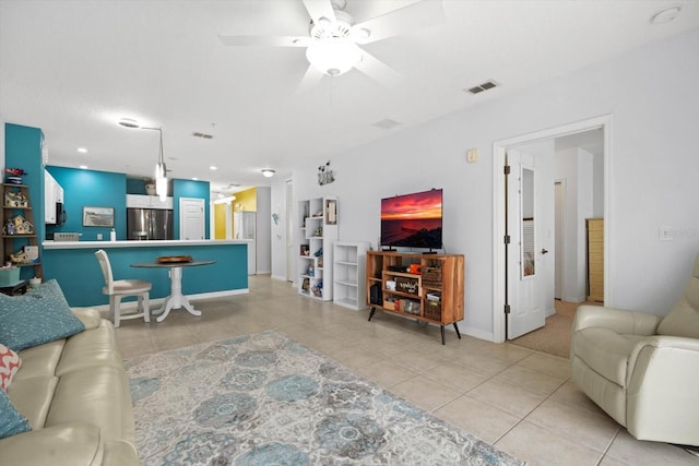 tiled living room featuring ceiling fan