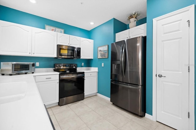 kitchen featuring sink, white cabinetry, light tile patterned floors, and stainless steel appliances