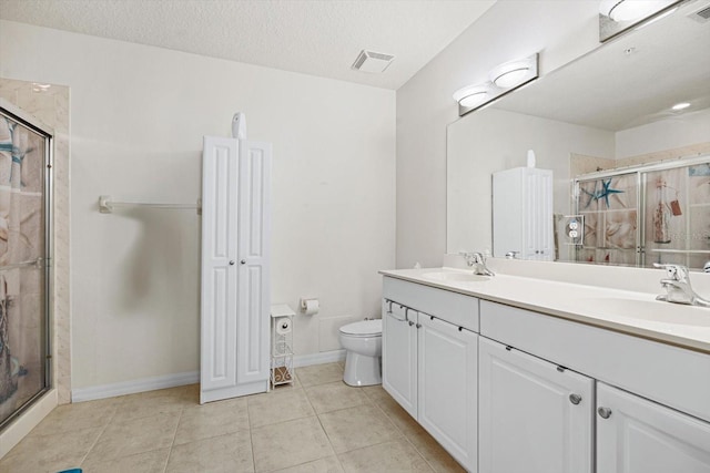 bathroom with toilet, tile patterned floors, an enclosed shower, a textured ceiling, and vanity