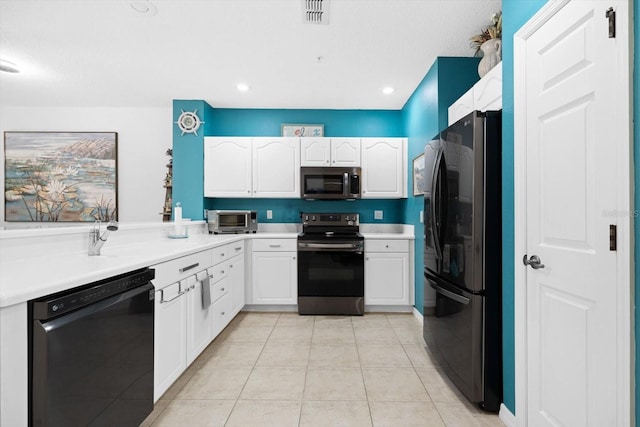 kitchen with black appliances, white cabinets, and light tile patterned floors