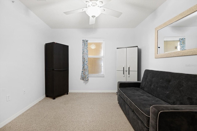 sitting room featuring light carpet and ceiling fan