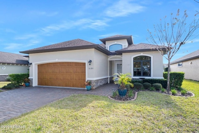 view of front of property with a front lawn and a garage