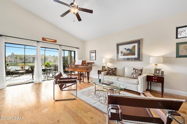 living room featuring ceiling fan, light wood-type flooring, and high vaulted ceiling