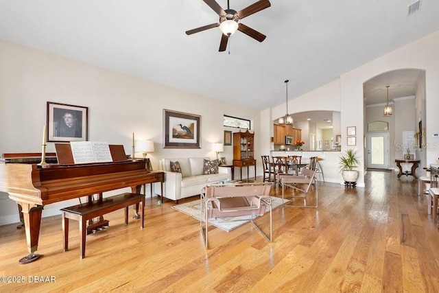 living room featuring ceiling fan and light hardwood / wood-style flooring