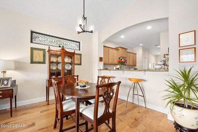 dining space featuring a chandelier and light hardwood / wood-style floors