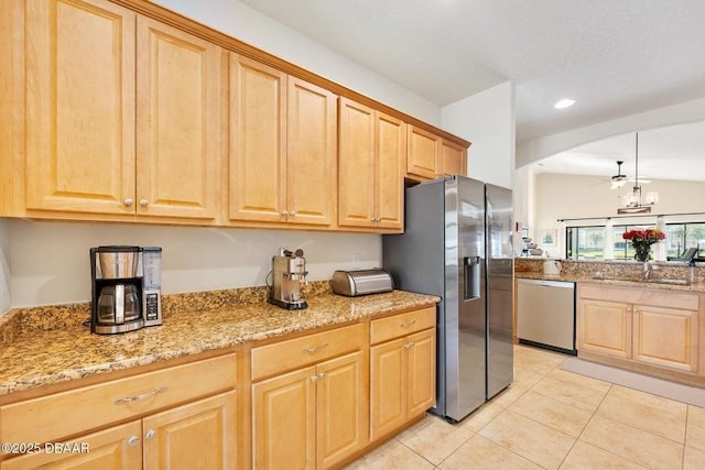 kitchen with stainless steel appliances, hanging light fixtures, light stone countertops, an inviting chandelier, and light tile patterned flooring