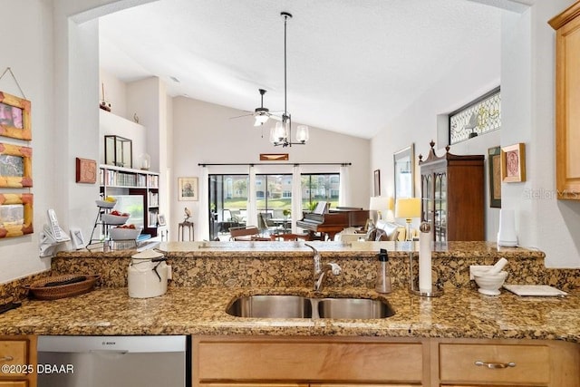 kitchen featuring sink, light stone counters, stainless steel dishwasher, ceiling fan with notable chandelier, and high vaulted ceiling