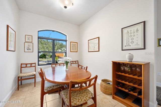 dining space featuring light tile patterned flooring