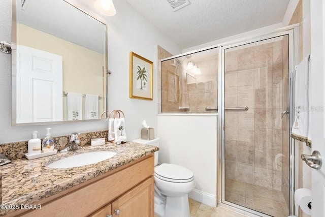 bathroom featuring toilet, tile patterned floors, vanity, a textured ceiling, and an enclosed shower